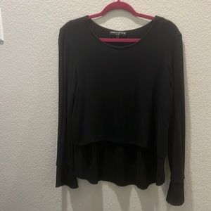 A black long sleeve top with details on the sleeves and bottom!